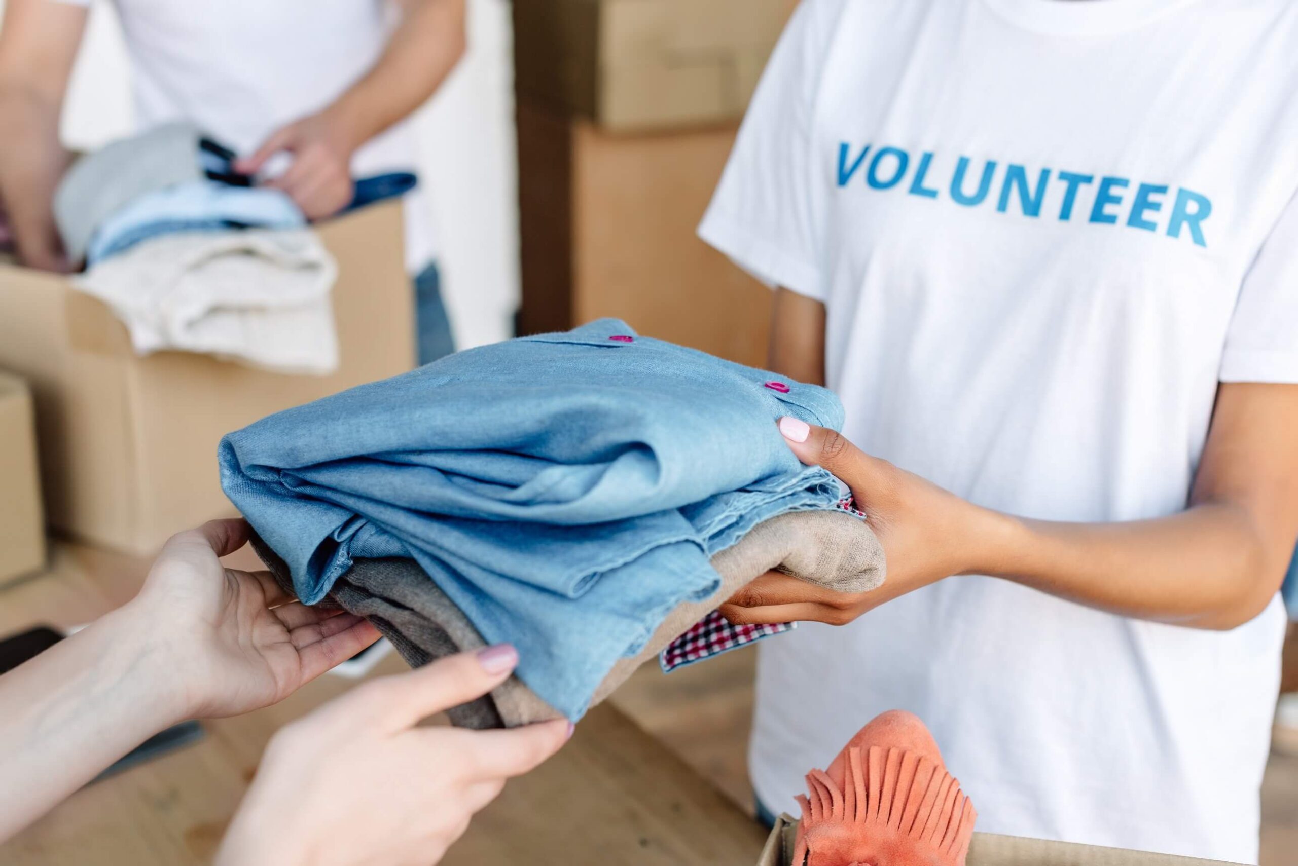 cropped view of volunteer giving clothes to woman 2022 12 16 21 31 45 utc